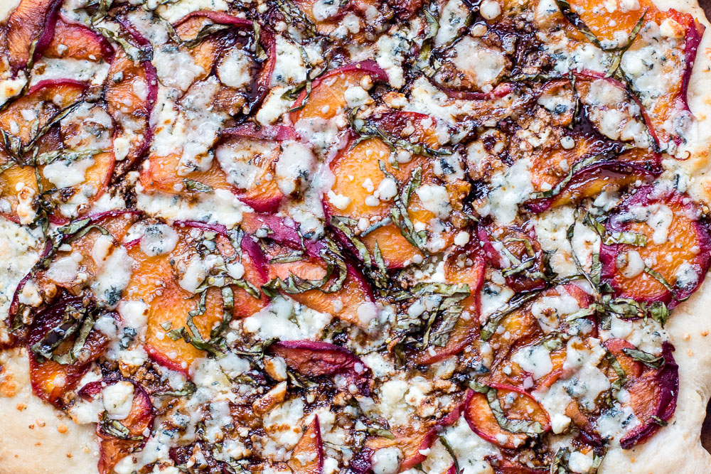 This Just Peachy Pizza uses summer peaches to the best advantage with goat cheese, basil, gorgonzola, and a balsamic drizzle that ties everything together. | www.megiswell.com