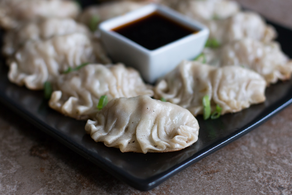 Homemade gyoza make a perfect savory side dish, stuffed with pork, cabbage, mushrooms, and aromatics. While they may seem intimidating to make from scratch, learn how to break them down into easy steps.