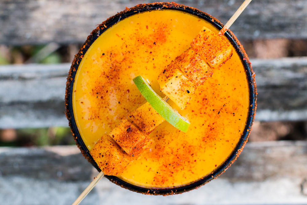 These Mango Margaritas spice things up a bit with a delicious turmeric simple syrup and a sprinkling of Tajin chili seasoning. They can also be frozen and taken to-go on picnics.