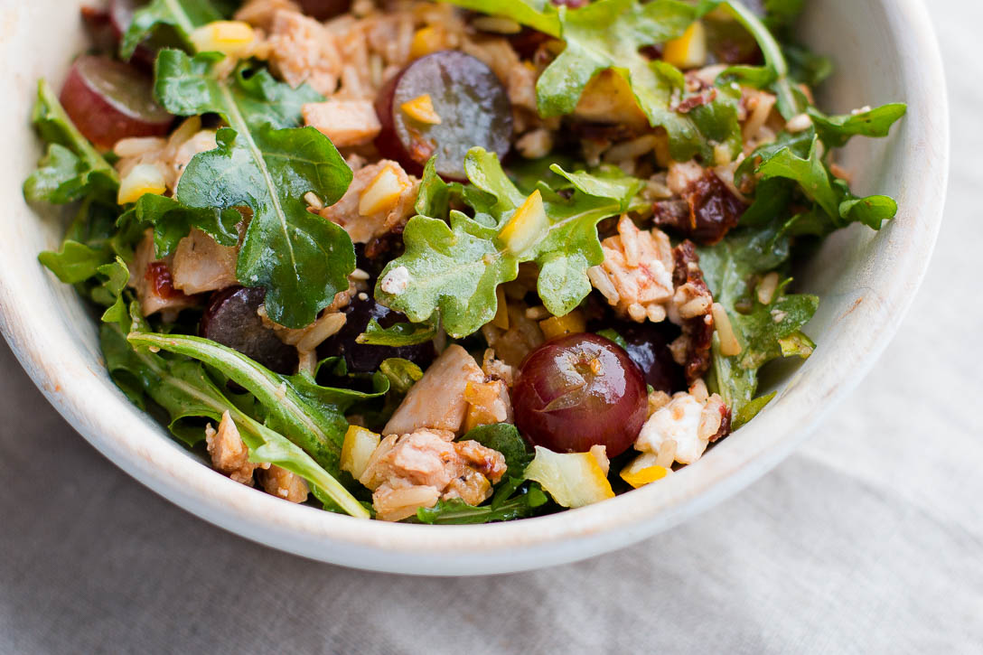 <yoastmark class='yoast-text-mark'>This Leftover Chicken Bowl Recipe is an easy and quick way to get rid of leftovers.</yoastmark> Brown rice, sun dried tomatoes, preserved lemon, feta, grapes, and arugula combine for a light, healthy, and filling bowl. | www.megiswell.com