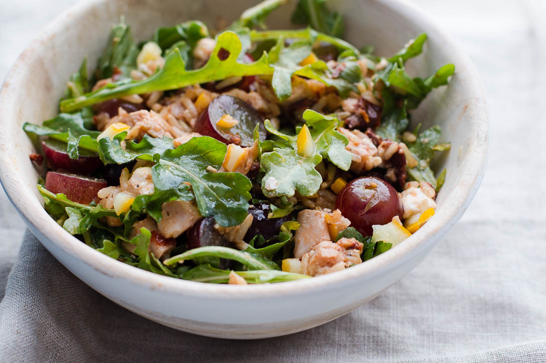 <yoastmark class='yoast-text-mark'>This Leftover Chicken Bowl Recipe is an easy and quick way to get rid of leftovers.</yoastmark> Brown rice, sun dried tomatoes, preserved lemon, feta, grapes, and arugula combine for a light, healthy, and filling bowl. | www.megiswell.com