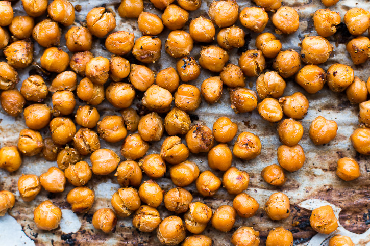 Seasoned and roasted chickpeas provide flavor and protein in this Preserved Lemon and Chickpea Arugula Salad while preserved lemons and feta lightly coat the arugula for a healthy and quick salad. | www.megiswell.com