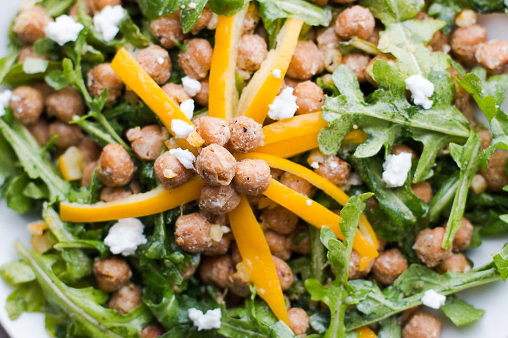 Seasoned and roasted chickpeas provide flavor and protein in this Preserved Lemon and Chickpea Arugula Salad while preserved lemons and feta lightly coat the arugula for a healthy and quick salad. | www.megiswell.com