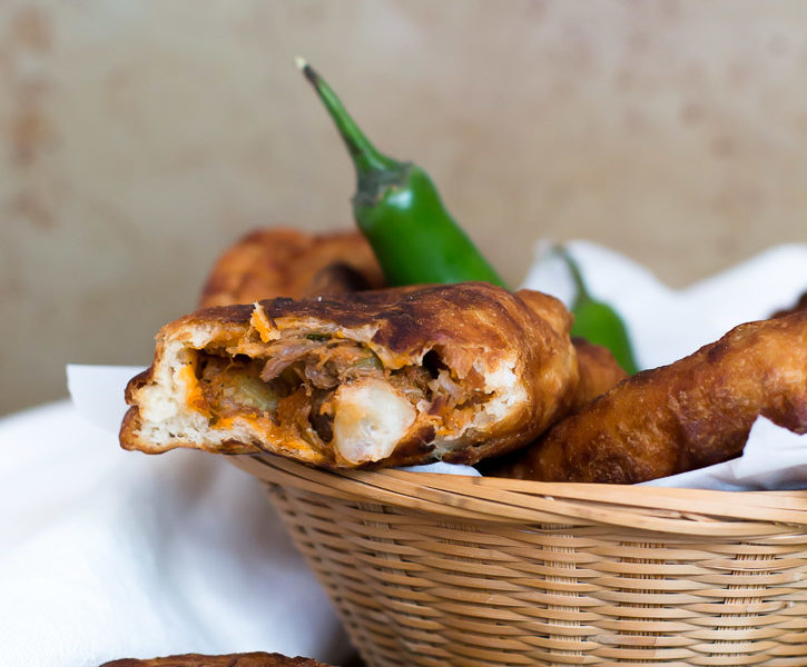 Use your leftover pulled pork for these Shredded Pork Empanadas. Fire roasted tomatoes and chilies in adobo sauce create a fiery sauce and poblano peppers add smoky flavor to the filling. Dip them in a delicious Adobo Aioli Dip made from the sauce. | www.megiswell.com