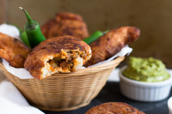 Use your leftover pulled pork for these Shredded Pork Empanadas. Fire roasted tomatoes and chilies in adobo sauce create a fiery sauce and poblano peppers add smoky flavor to the filling. Dip them in a delicious Adobo Aioli Dip made from the sauce. | www.megiswell.com