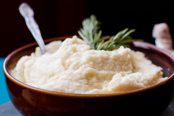 Horizontal close up side shot of a bowl filled with cauliflower potato mash.
