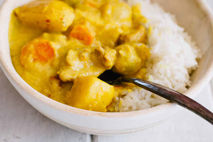 Thai Yellow Curry with Chicken is the ultimate comfort food. Yukon gold potatoes, pearl onions, sliced carrots, and bite-sized pieces of chicken soak up all the wonderful creaminess of curry, coconut cream, and coconut milk, making each bite heaven. | www.megiswell.com