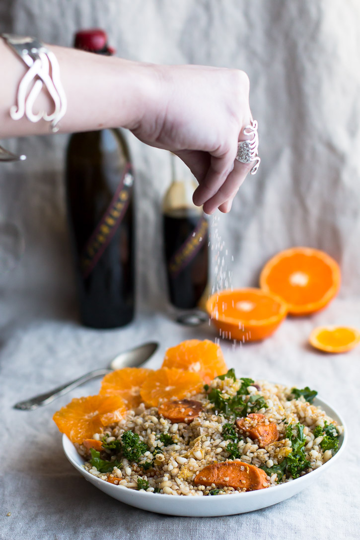 This Citrus, Kale, and Grain Salad is an amazing winter salad that is a combination of roasted oranges, red onion, and sweet potato-which provide sweet and fresh bursts of flavor, massaged kale, and roasted barley and quinoa, which adds depth and bulk. | www.megiswell.com