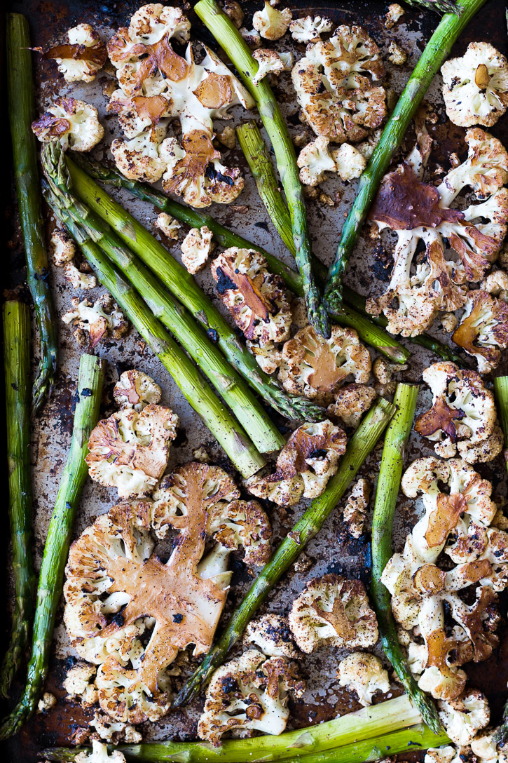 Oven Roasted Cauliflower Steaks with Black Garlic and Asparagus is a very simple and quick one-sheet meal that has a ton of flavor thanks to the umami of black garlic. | www.megiswell.com