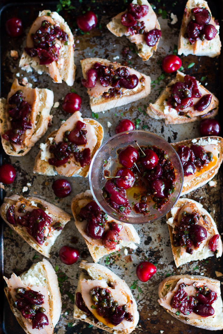 A sweet and slightly tart Roasted Cherry Caper Sauce, creamy goat cheese, and flavor packed hickory smoked turkey breast on toasted ciabbata bread make an easy summer appetizer. | Sponsored by Jennie-O | www.megiswell.com