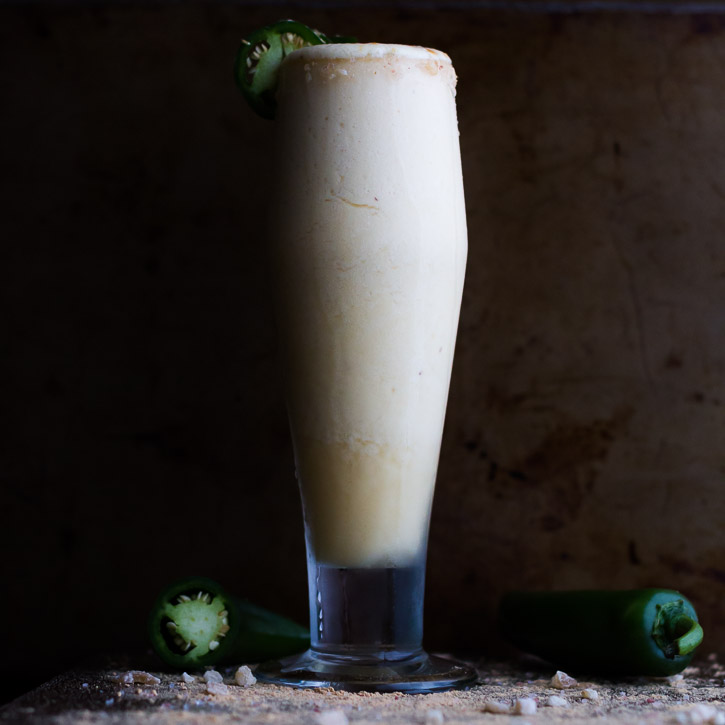 The classic rum painkiller cocktail is remixed as a Frozen Pineapple Painkiller Margarita with Ginger and Jalapeño. | www.megiswell.com