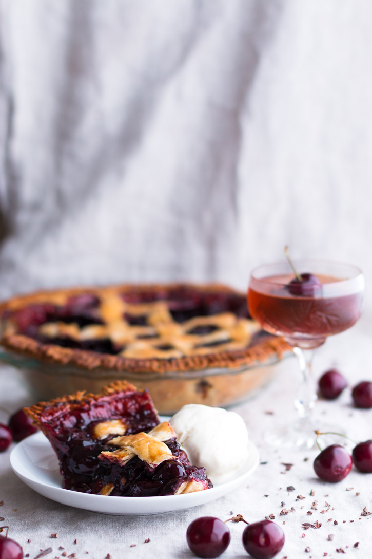 This Bourbon Cherry Pie with Cocoa Nibs is for bourbon and cocoa lovers. Dark and bitter chocolate melds beautifully with the vanilla undertones of bourbon and the sweetness of fresh dark cherries. Serve with a Bourbon Soaked Cherry Old Fashioned. | Dessert & Cocktail | www.megiswell.com