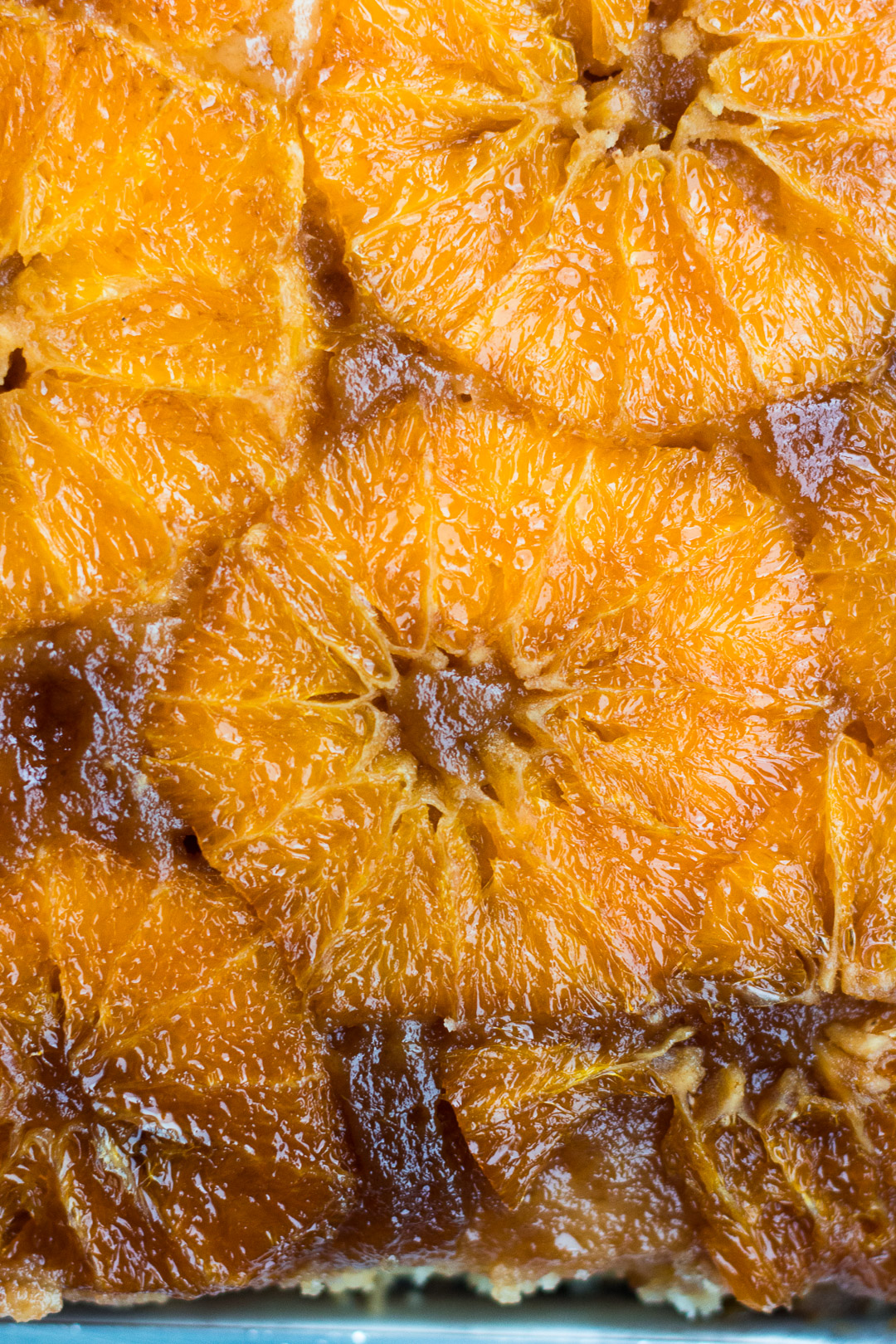 Close up overhead shot of the unglazed oranges on the upside down cake.