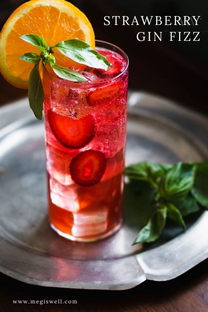 This Strawberry Gin Fizz is fruity & herbaceous with a current of bright strawberry-orange flavor, a slight peppery undertow, and refreshing basil aroma. | Gin Bar | DIY | Cocktail Recipe | #ginfizz #shrubcocktail #strawberryshrub #megiswell #meganwellsphotography | www.megiswell.com