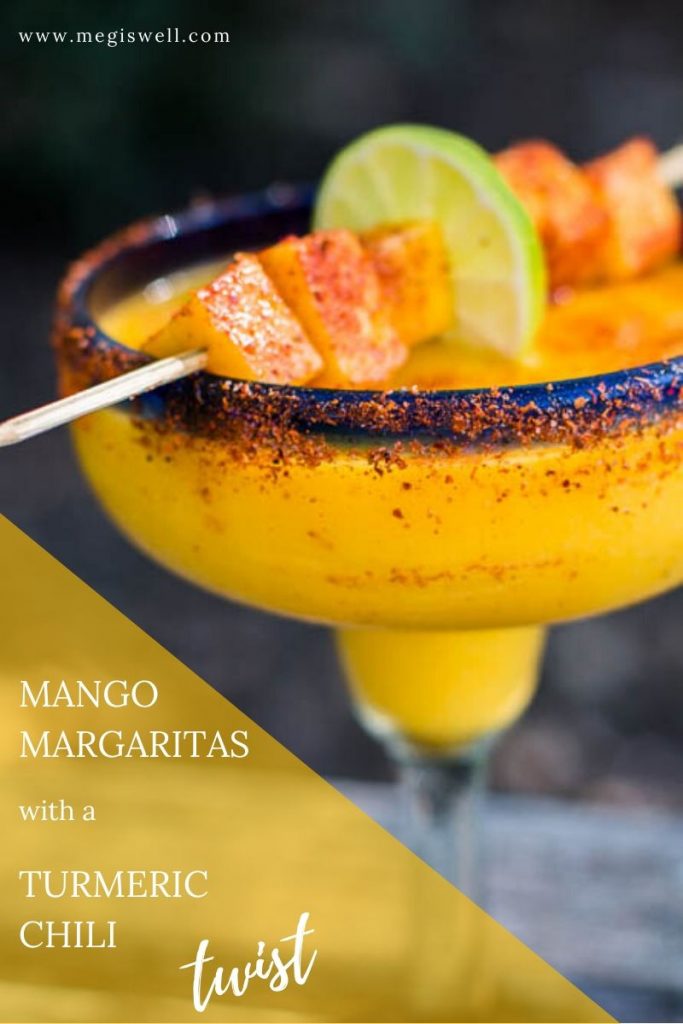 These Mango Margaritas spice things up a bit with a delicious turmeric simple syrup and a sprinkling of Tajin chili seasoning. They can also be frozen and taken to-go on picnics. | Recipe Blended | Tajin Recipes | #mangomargaritas | www.megiswell.com