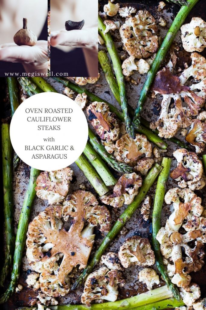 Oven Roasted Cauliflower Steaks with Black Garlic and Asparagus is a very simple and quick one-sheet meal that has a ton of flavor thanks to the umami of black garlic. | #blackgarlic #onesheetmeal #cauliflowersteaks | www.megiswell.com